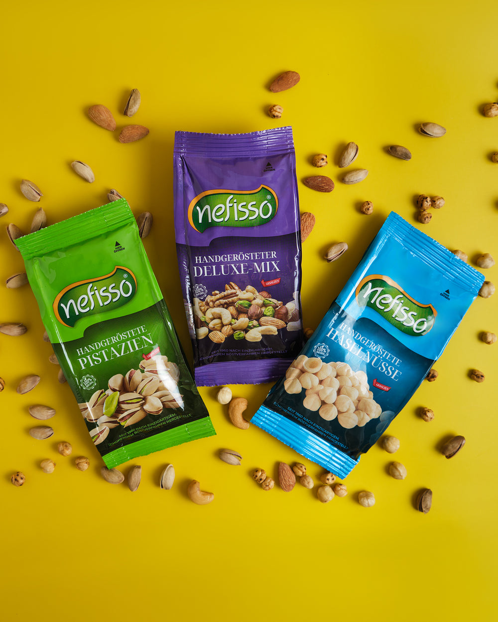 Nefisso Pistazien, Deluxe Mix und Haselnüsse mit Nüssen auf gelbem Hintergrund